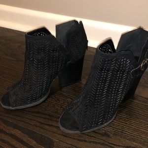 Loosely worn black peep-toe booties